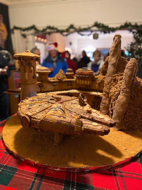 A gingerbread version of the Millennium Falcon  is the centerpiece of a 'Star Wars"-themed party at the Wert home, in the Virginia Highland/Morningside neighborhood. Friends gathered for Wookiee Cookies and baked Brie Brie 8 before catching the new film, "The Rise of Skywalker." CONTRIBUTED: MOLLY PRATT