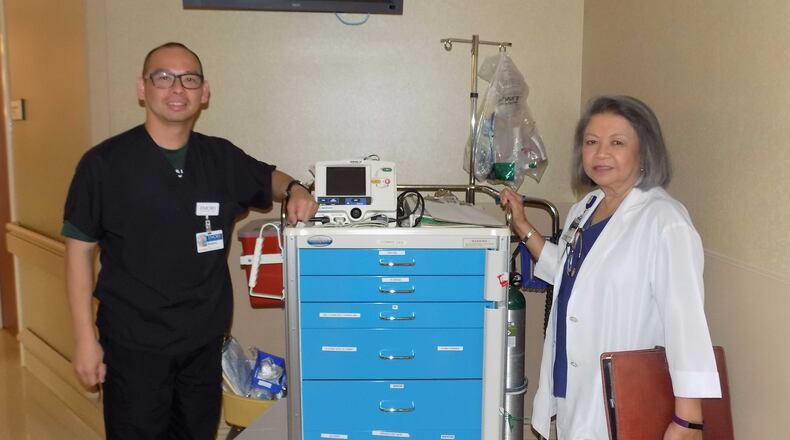 Roland Tam, left, and Angelina Trinidad  treated about 500 people, they say, inside a Texas high school gym that flipped into a “makeshift emergency room."