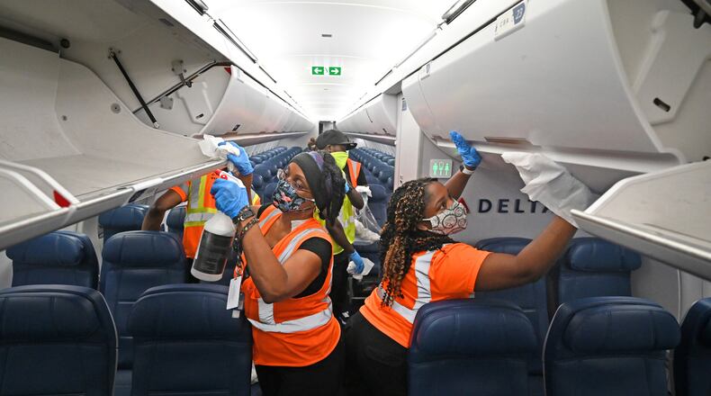 In this file photo, cleaning crew thoroughly wipe down aircraft cabin on Concourse A at Hartsfield-Jackson International Airport on Wednesday, July 22, 2020. Despite recieving the CARES Act funding from the goverment, the aviation still laid off and furloughed its employees. (Hyosub Shin/Atlanta Journal-Constitution/TNS)