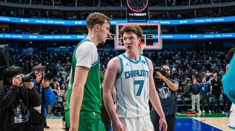 Dallas Mavericks forward Cooper Flagg, center left, and Charlotte Hornets guard Kon Knueppel (7) talk after an NBA basketball game, Thursday, Jan. 29, 2026, in Dallas. (AP Photo/Jessica Tobias)