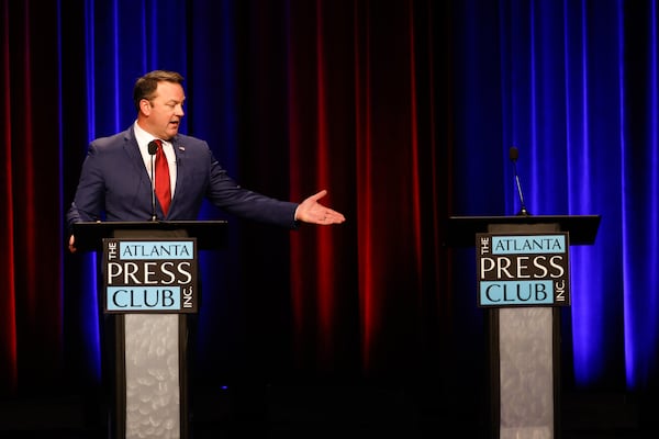Lt. Gov. Burt Jones, a Republican candidate for governor, gestures to the empty lectern at the Atlanta Press Club Loudermilk-Young Debate Series on Monday. His opponent, Rick Jackson, did not attend, citing a scheduling conflict. (Arvin Temkar/AJC)