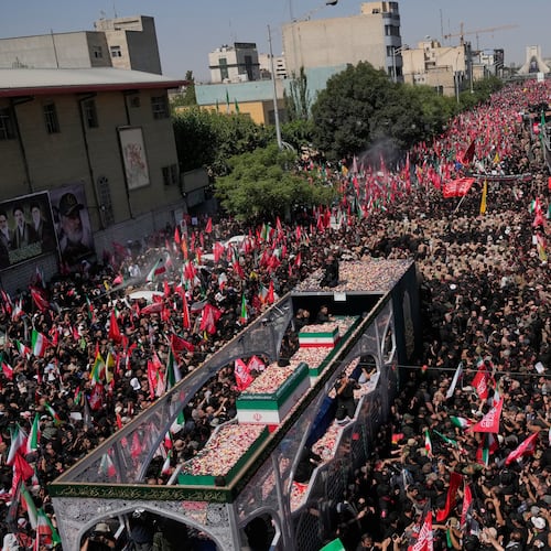 The truck carrying the coffins of the slain Iranian Supreme Leader Ayatollah Ali Khamenei and members of his family makes its way through mourners during the funeral procession toward Azadi Tower in Tehran, Iran, Monday, July 6, 2026. (AP Photo/Vahid Salemi)
