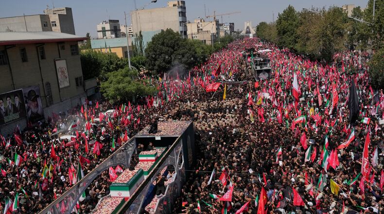 The truck carrying the coffins of the slain Iranian Supreme Leader Ayatollah Ali Khamenei and members of his family makes its way through mourners during the funeral procession toward Azadi Tower in Tehran, Iran, Monday, July 6, 2026. (AP Photo/Vahid Salemi)