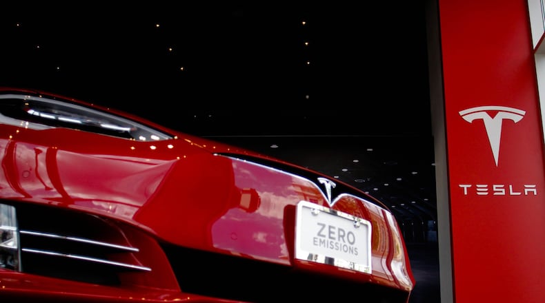 A Tesla electric vehicle sits in the new dealership at the Avalon development in Alpharetta. The Tesla-owned retail store, which opened April 27, 2016, is the fourth of only five the company is allowed by law in Georgia. TAYLOR CARPENTER / TAYLOR.CARPENTER@AJC.COM