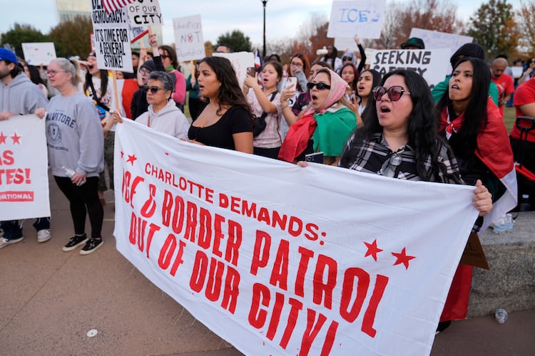 People protest against federal immigration enforcement Saturday, Nov. 15, 2025, in Charlotte, N.C. (AP Photo/Erik Verduzco)