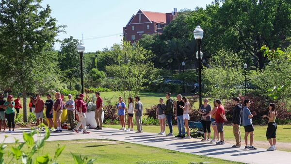 Students wait to retrieve their personal items from the Florida State Student Union building, Tallahassee, Fla., Friday, April 18, 2025. (AP Photo/Gary McCullough)