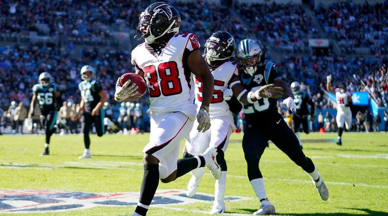 Kenjon Barner  of the Atlanta Falcons returns a punt for a touchdown during the first quarter during their game against the Carolina Panthers at Bank of America Stadium on November 17, 2019 in Charlotte, North Carolina. (Photo by Jacob Kupferman/Getty Images)