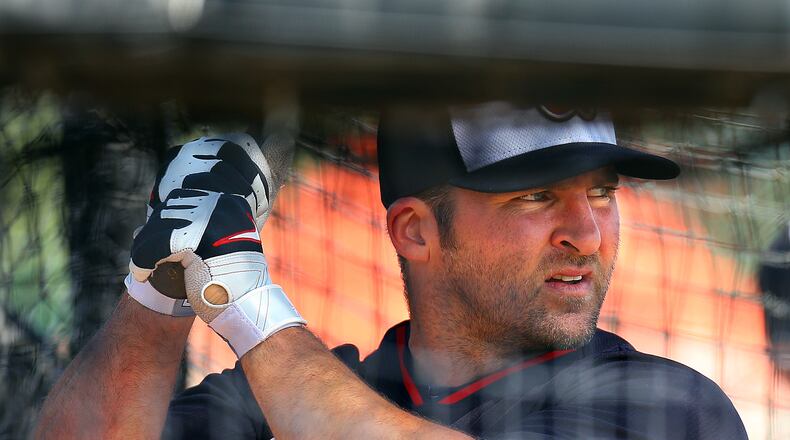 Braves second baseman Dan Uggla gets some work in the batting cage on the full squad first workout on Wednesday, Feb. 19, 2014, in Lake Buena Vista, FL.