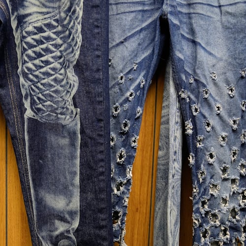 Patterns and distressing, made by a laser, are displayed at the BPD Washhouse, a denim processing facility, in Jersey City, N.J., Tuesday, May 5, 2026. (AP Photo/Seth Wenig)