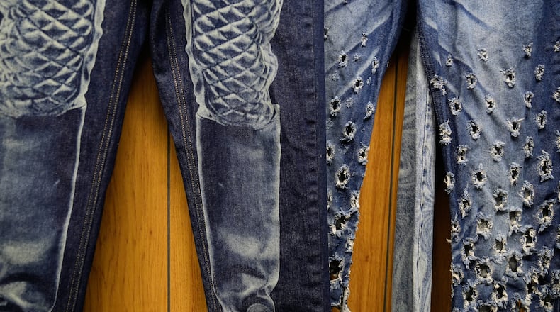Patterns and distressing, made by a laser, are displayed at the BPD Washhouse, a denim processing facility, in Jersey City, N.J., Tuesday, May 5, 2026. (AP Photo/Seth Wenig)