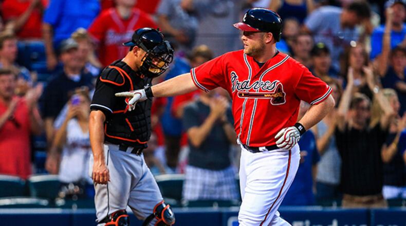 Aug 9, 2013; Atlanta, GA, USA; Atlanta Braves catcher Brian McCann (16) celebrates a solo home run in the third inning against the Miami Marlins at Turner Field. Mandatory Credit: Daniel Shirey-USA TODAY Sports