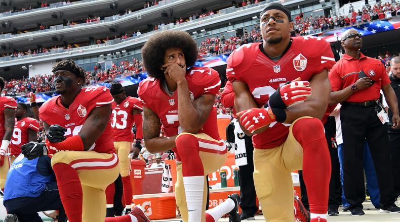SANTA CLARA, CA - OCTOBER 02: (L-R) Eli Harold #58, Colin Kaepernick #7 and Eric Reid #35 of the San Francisco 49ers kneel on the sideline during the anthem prior to the game against the Dallas Cowboys at Levi's Stadium on October 2, 2016 in Santa Clara, California. (Photo by Thearon W. Henderson/Getty Images)