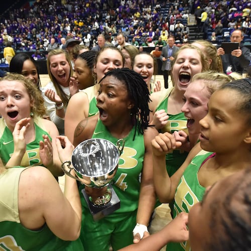 The Buford girls basketball team (pictured) celebrates its 2019 state championship, matching the Wolves' feat in boys basketball that year. The school also won the boys and girls titles in 2017. (Hyosub Shin/AJC)