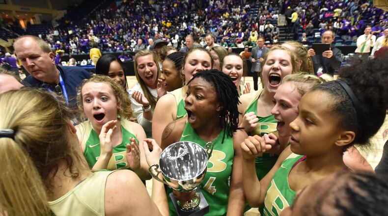 The Buford girls basketball team (pictured) celebrates its 2019 state championship, matching the Wolves' feat in boys basketball that year. The school also won the boys and girls titles in 2017. (Hyosub Shin/AJC)