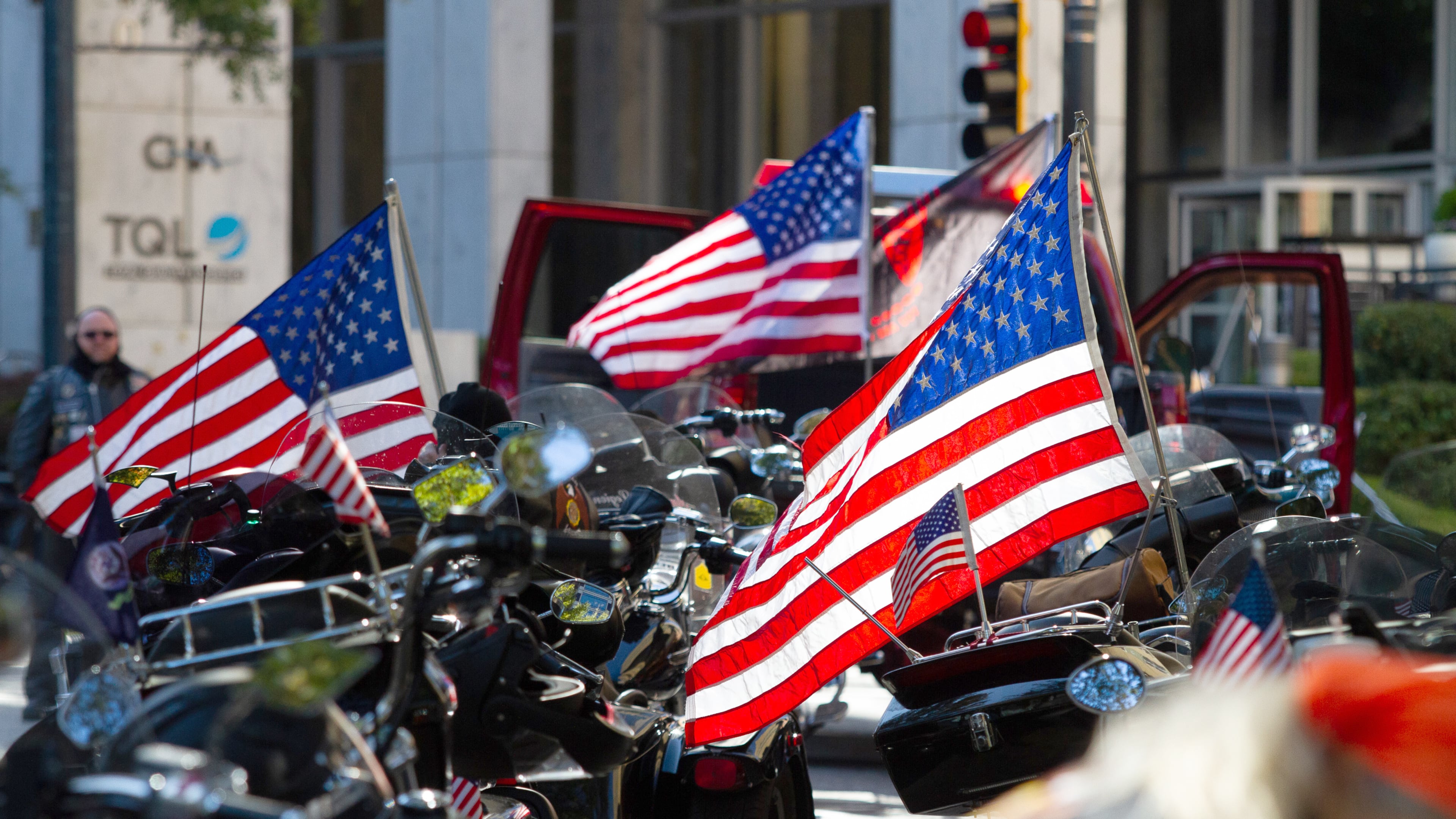 Motorcycles and American flags are lined up on Peachtree Street waiting for the start of a previous Veterans Day Parade in Atlanta. (AJC file)