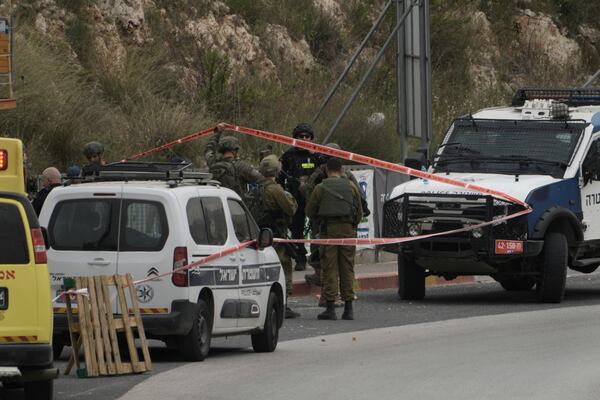 Israeli forces work at the site where soldiers shot and killed a Palestinian woman who they said had thrown rocks at them and tried to stab them at the Gitai Avisar junction near the West Bank settlement of Ariel, Tuesday, April 8, 2025. (AP Photo/Majdi Mohammed)