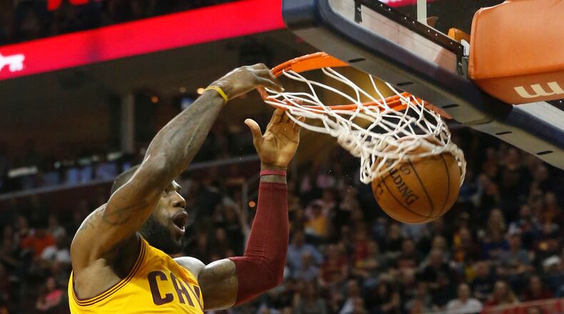 LeBron James of the Cleveland Cavaliers dunks against the Brooklyn Nets during the second quarter at Quicken Loans Arena in Cleveland on Thursday, March 31, 2016. (Karen Schiely/Akron Beacon Journal/TNS)