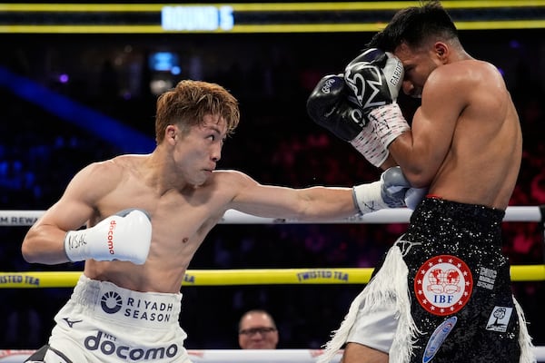 Naoya Inoue hits Ramon Cardenas in a junior featherweight title boxing match Sunday, May 4, 2025, in Las Vegas. (AP Photo/John Locher)