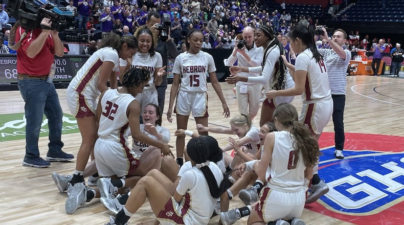Hebron Christian players celebrate their 68-36 victory over Lumpkin County in the Class 3A girls basketball championship game at the Macon Coliseum on March 10, 2023.