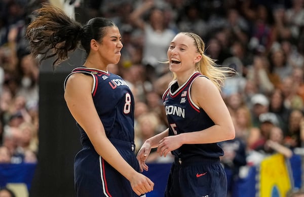 UConn center Jana El Alfy (8) and UConn guard Paige Bueckers (5) react during the first half of a national semifinal Final Four game against UCLA during the women's NCAA college basketball tournament, Friday, April 4, 2025, in Tampa, Fla. (AP Photo/Chris O'Meara)