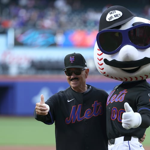 Former New York Mets manager Bobby Valentine, left, poses with Mr. Met after throwing out a ceremonial first pitch before a baseball game between the Mets and the Miami Marlins, Friday, May 29, 2026, in New York. (AP Photo/Pamela Smith)
