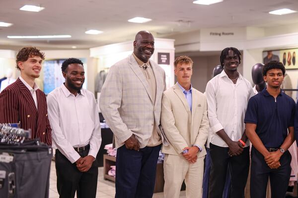 Shaquille O'Neal (center) poses with Clayton State University students (from left) Fabian Wagner, Daevon Gilley, Sonny Simpson, Mamour Mbow and Zachery Still as Shaq hosts a ‘Suit Up’ event at JCPenney in the South Point Shopping Center on April 24, 2026. (Jason Getz/AJC)