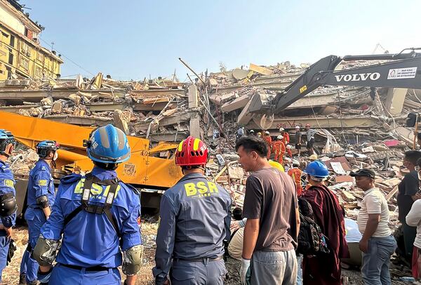 Rescuers work at the site of a building that collapsed In Friday's earthquake in Mandalay, Myanmar, Sunday, March 30, 2025. (AP Photo/Thein Zaw)