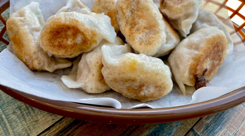 When you order the chicken and corn dumplings pan fried at Dumpling Factory, you get bottoms that are crisp and golden. (Angela Hansberger for The Atlanta Journal-Constitution)