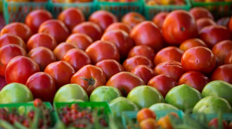 A wide range of different tomatoes are shown at Mountain Earth Farms, of Clarksville, Ga., during the Roswell Farmes and Artisans Market in 2018. PHOTO / JASON GETZ