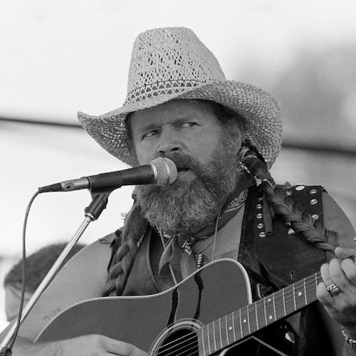 FILE - David Allan Coe, sporting Willie Nelson braids, performs at the Willie Nelson July 4th Picnic, on July 4, 1983 at Atlanta International Raceway in Hampton, Ga. (AP Photo/Rudolph Faircloth, File)