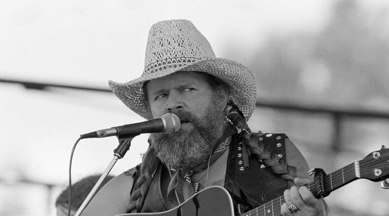 FILE - David Allan Coe, sporting Willie Nelson braids, performs at the Willie Nelson July 4th Picnic, on July 4, 1983 at Atlanta International Raceway in Hampton, Ga. (AP Photo/Rudolph Faircloth, File)