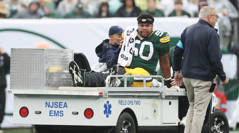 Green Bay Packers guard Zach Bako-Bewele (50) is taken off the field following an injury during an NFL football game against the New York Jets in East Rutherford, N.J., Sunday, Sept. 20, 2026. (AP Photo/Adam Hunger)
