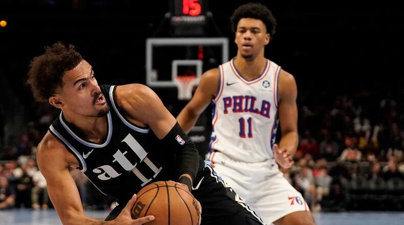 Atlanta Hawks guard Trae Young (11) works against Philadelphia 76ers guard Jaden Springer (11) during the first half of an In-Season Tournament NBA basketball game, Friday, Nov. 17, 2023, in Atlanta. (AP Photo/Mike Stewart)