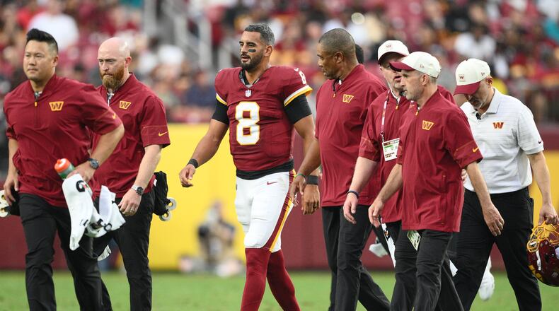 Washington Commanders quarterback Marcus Mariota (8) walks off the field during the first half of an NFL preseason football game against the Miami Dolphins, Friday, Aug. 14, 2026, in Landover, MD. (AP Photo/Nick Wass)