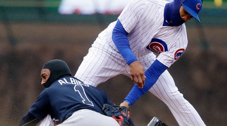 Braves’ Ozzie Albies slides into second with a double in April 14 game at Chicago. The next day’s game was postponed by cold weather and a wintry mix of precipitation and will be made up Monday on what would’ve been a Braves off day. (AP Photo/Nam Y. Huh)
