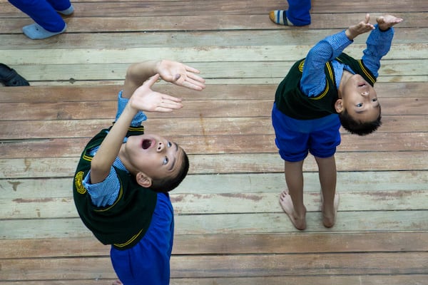 Exiled Tibetan children perform an exercise as they mark International Day of Yoga at the Tibetan Children's Village School in Dharamshala, India, Saturday, June 21, 2025. (AP Photo/Ashwini Bhatia)