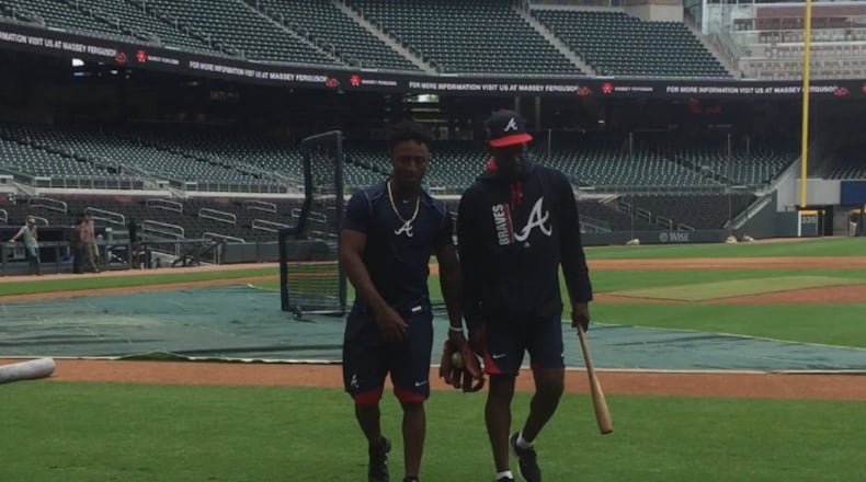 Braves second baseman Ozzie Albies chats with third base coach Ron Washington at SunTrust Park prior to playing the Dodgers on Tuesday afternoon. Albies, 20, debuted as the youngest player in the majors. (Gabriel Burns / AJC)