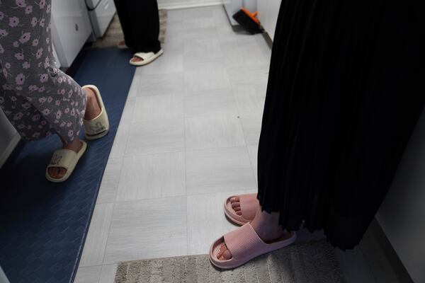 Marjila Badakhsh and her roommates wear sandals while cooking together in their apartment in Alexandria, Va., Wednesday, March 5, 2025. (AP Photo/Jessie Wardarski)