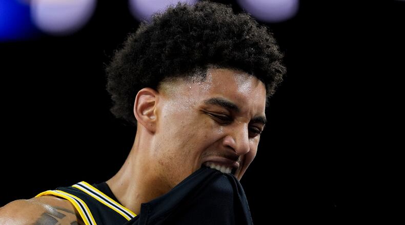 Michigan forward Yaxel Lendeborg reacts after an injury on the court during the first half of an NCAA college basketball tournament semifinal game against Arizona at the Final Four, Saturday, April 4, 2026, in Indianapolis. (AP Photo/Abbie Parr)