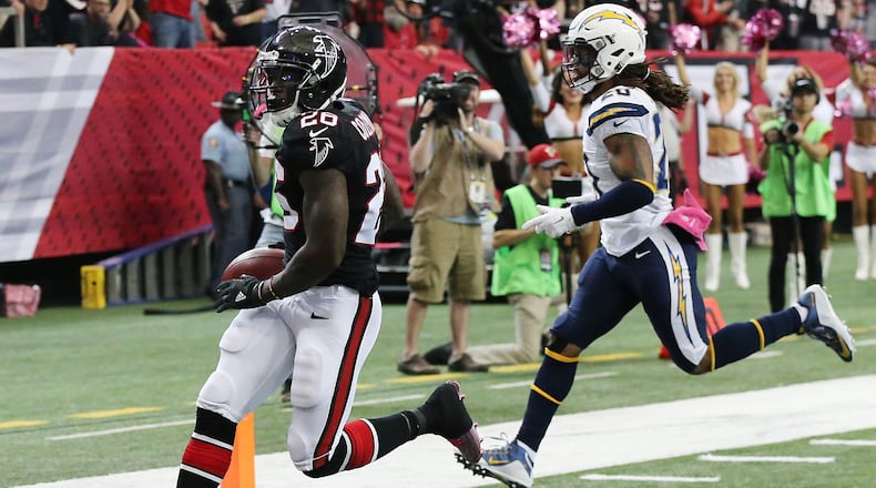Falcons running back Tevin Coleman gets past Chargers safety Dwight Lowery for a touchdown and a 20-10 lead during the second quarter in an NFL football game on Sunday, Oct. 23, 2016, in Atlanta. Curtis Compton /ccompton@ajc.com
