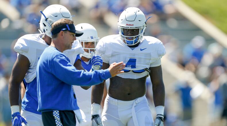 UK linebacker Joshua Paschal listens to offensive coordinator Eddie Gran during UK Football Fan Day open practice at Joe Craft Football Training Facility in Lexington, Ky., on Saturday, August 5, 2017.