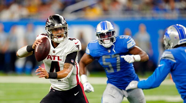 Atlanta Falcons quarterback Desmond Ridder (4) scrambles during the second half of a preseason NFL football game against the Detroit Lions, Friday, Aug. 12, 2022, in Detroit. (AP Photo/Paul Sancya)