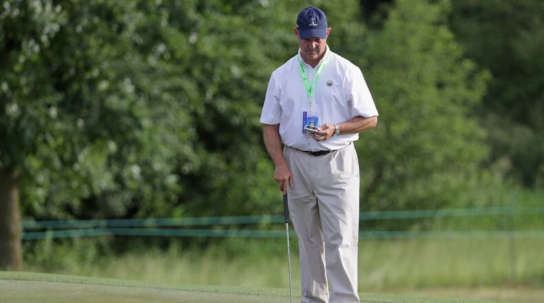 Mike Davis, USGA executive director, does his homework earlier this week at the U.S. Open. (Streeter Lecka/Getty Images)