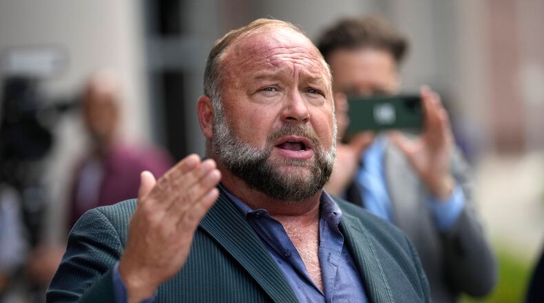 FILE - Right-wing conspiracy theorist Alex Jones speaks to the media after arriving at the federal courthouse for a hearing in front of a bankruptcy judge in Houston, June 14, 2024. (AP Photo/David J. Phillip, File)
