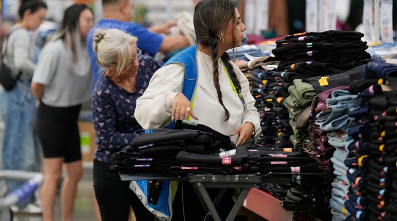 File - A worker stocks a display of clothing at a Sam's Club, Wednesday, Sept. 24, 2025, in Bentonville, Ark. (AP Photo/Charlie Riedel, File)
