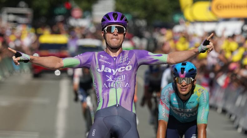 Switzerland's Mauro Schmid celebrates as he crosses the finish line ahead of Colombia's Harold Tejada, right, to win the thirteenth stage of the Tour de France cycling race with start in Dole and finish in Belfort, France, Friday, July 17, 2026. (AP Photo/Thibault Camus)