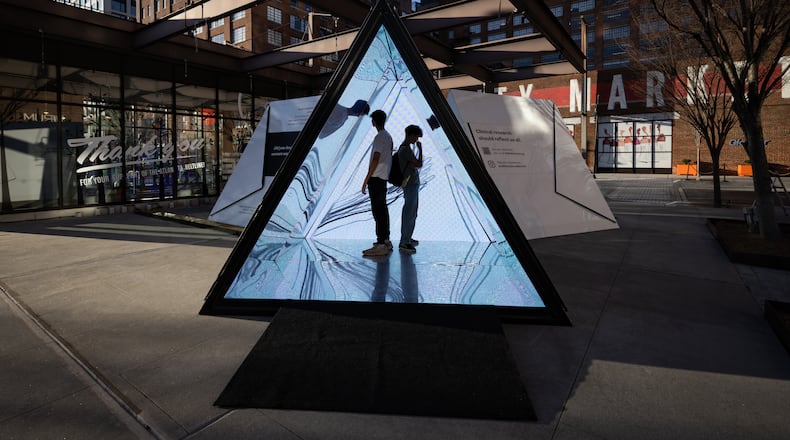Visitors venture inside a kaleidoscope by Atlanta artist William Downs. The artwork is part of a pop-up exhibit at Ponce City Market by Dash Studio that focuses on themes of health, wellness and medicine. (Courtesy of Dash Studio)