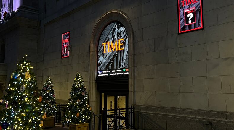 A sign for Time magazine is displayed outside the New York Stock Exchange on Thursday, Dec. 11, 2025 in New York. (AP Photo/Donald King)