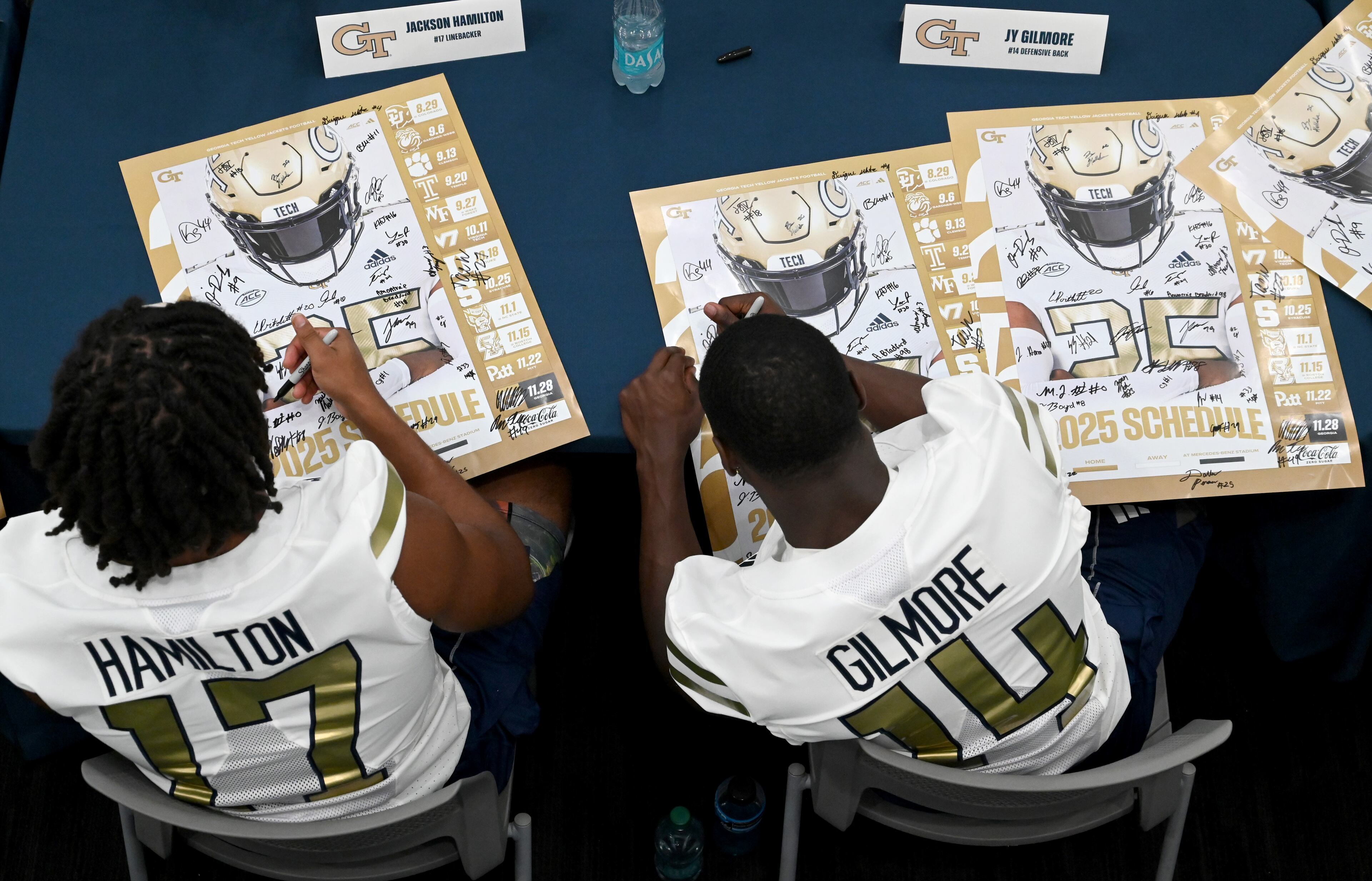 Georgia Tech football players sign autographs for event attendees during the annual “First Saturday on The Flats” at Bobby Dodd Stadium, Saturday, August 2, 2025, in Atlanta. The Flats provides Tech fans with the opportunity to engage with their favorite Yellow Jackets ahead of the upcoming 2025 season. The event offers a variety of entertaining activities for the whole family, including a DJ, autograph opportunities, tailgate games and interactive experiences right on the field at Bobby Dodd Stadium. (Hyosub Shin / AJC)