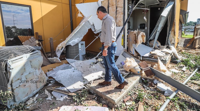 Armin Oskouei surveys his damaged building in Sandy Springs.